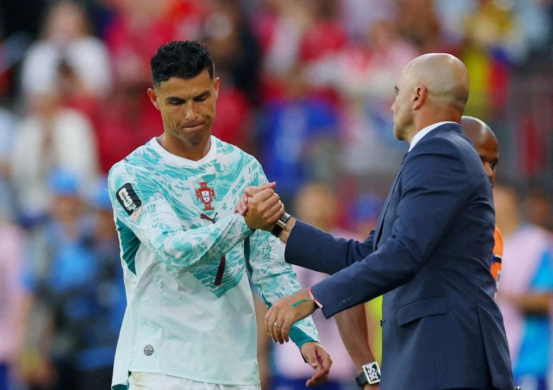 Portugal's Cristiano Ronaldo with coach Roberto Martinez as he reacts after being substituted off on Thursday. (Photo: Reuters)