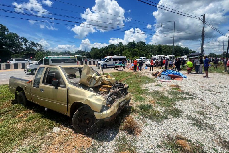 A pickup truck driven by an 11-year-old boy sits at the scene after it ploughed into a group of monks on a pilgrimage in Mukdahan province on Thursday, killing 10 monks. (Photo: Highway Police)