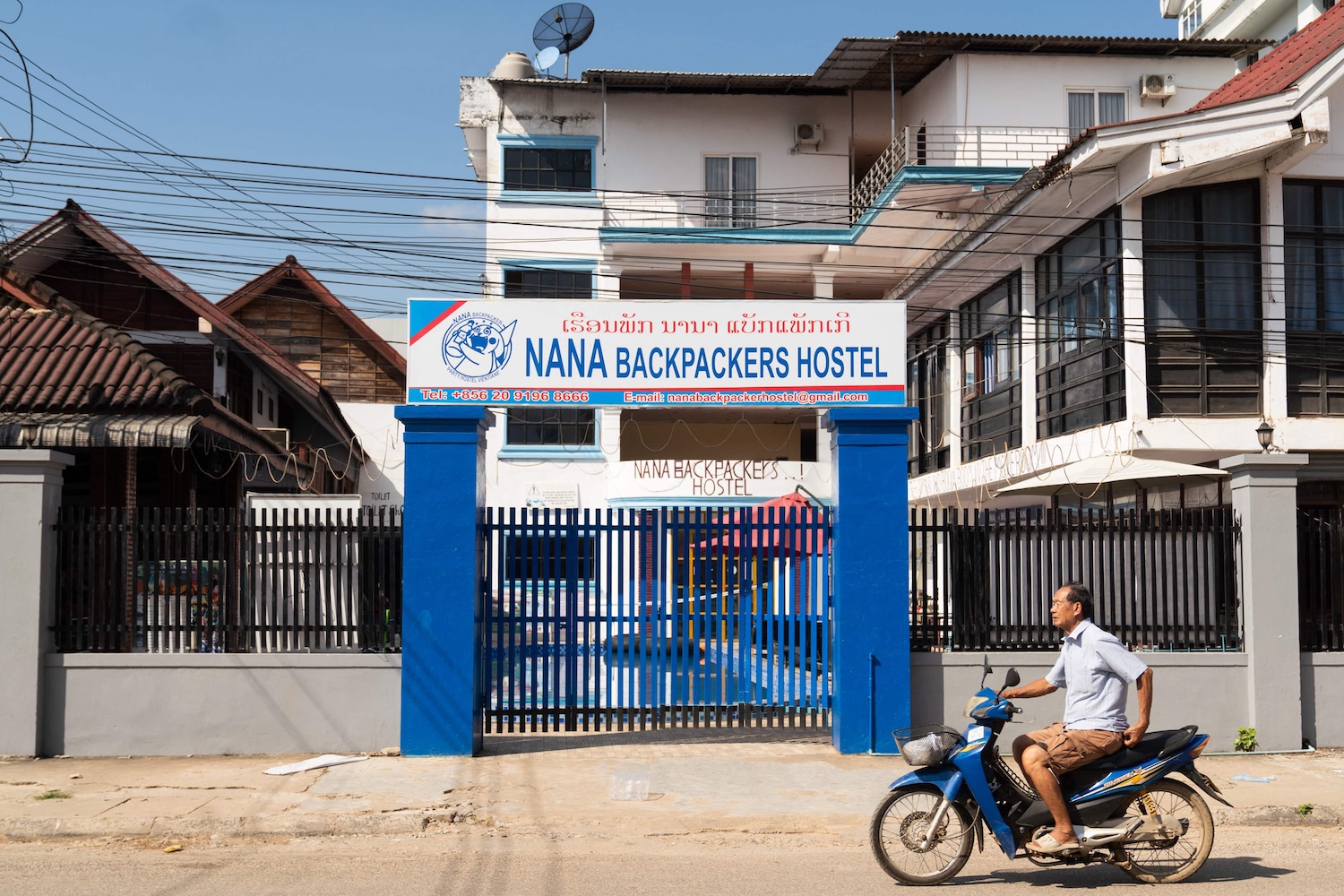 A motorcyclist rides past the Nana Backpackers Hostel in Vang Vieng, Laos on Nov 24, 2024. The owner and 10 employees of the hostel are facing charges in connection with the death of an American, one of six tourists who died after drinking methanol-laced liquor. (Photo: AFP)