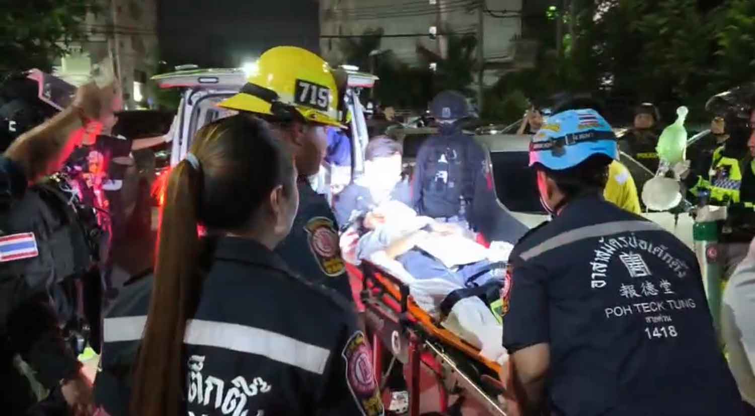 Rescue workers help the injured at the crash scene.