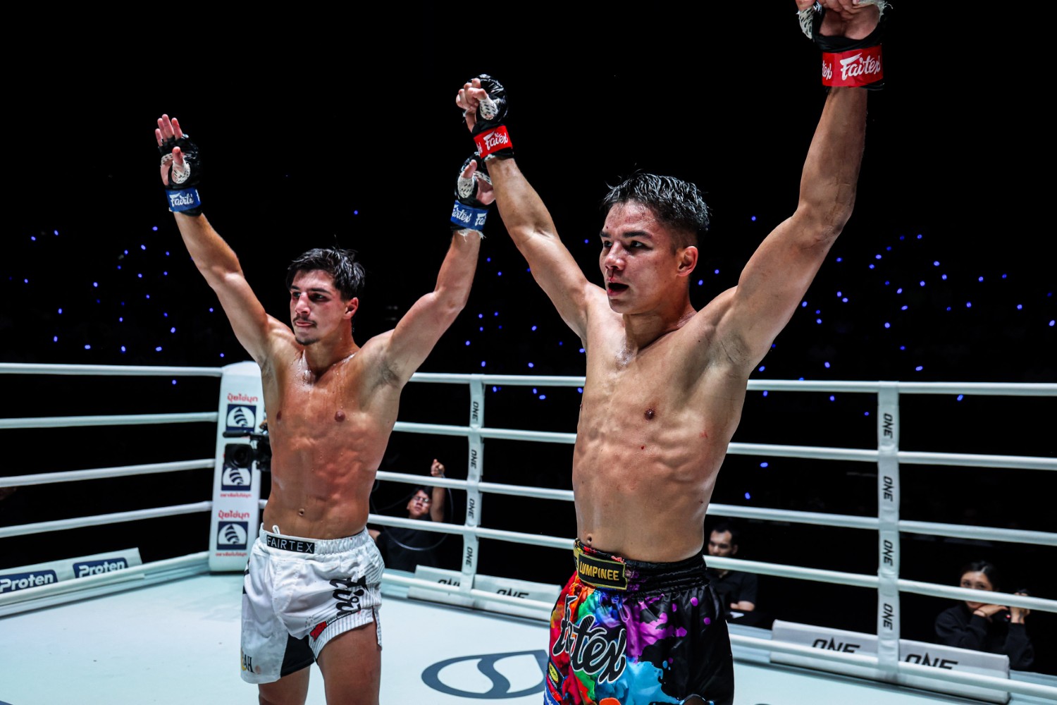 Ramadan Ondash and Johan Ghazali raise their arms after three closely contested rounds in Bangkok