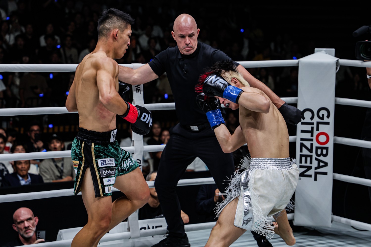 Masaaki Noiri lands a a left hook on Liu Mengyang to end their featherweight kickboxing tournament quarter-final