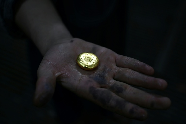 An Afghan goldsmith holds gold at a workshop in Fayzabad, in Afghanistan's northeastern Badakhshan province. afp