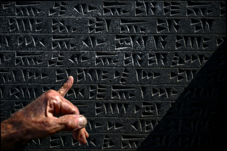 Kusman runs his finger over a tablet engraved with the ancient Urartu language. afp