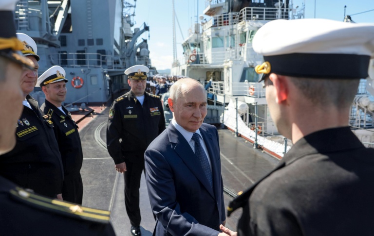 President Vladimir Putin shakes hands with officers onboard the Russian Navy’s guided missile cruiser Varyag during naval drills on the far eastern Sakhalin Island on Aug 13, 2026. (Pool Photo via AFP)