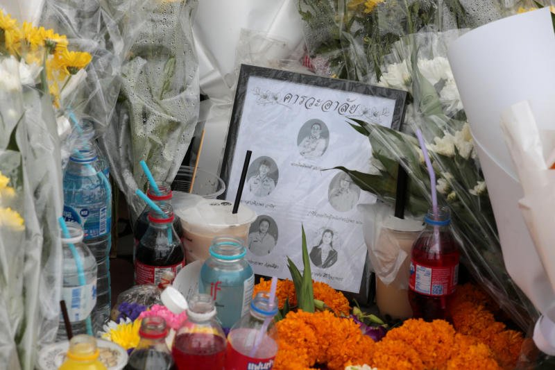 Flowers, garlands and drinks are placed in front of Debsirin Nonthaburi School in Nonthaburi province to mourn the victims of the Aug 7 shooting rampage. (Photo: Chanat Katanyu)