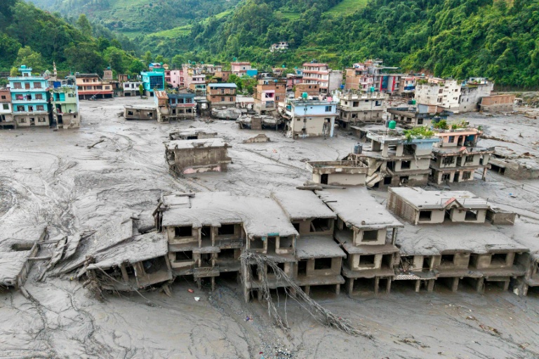 A tsunami-like wall of water and mud swept through villages and towns in Nepal on Wednesday, leaving hundreds missing. (Photo: AFP)