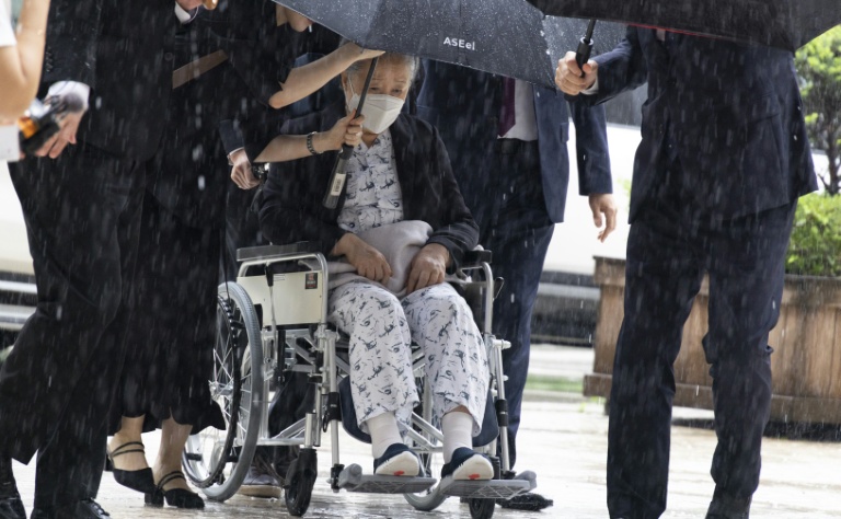 Unification Church leader Han Hak-ja (in wheelchair) arrives for the sentencing at the Seoul Central District Court