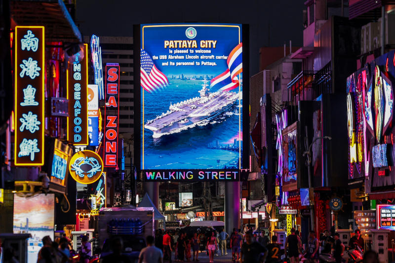 People walk past an LED display welcoming US service personnel from the US Nimitz-class aircraft carrier USS Abraham Lincoln, which is docked at Laem Chabang Port for a rest stop following a long deployment in the Middle East, in Pattaya City, Thailand, on Thursday. (Photo: Reuters)