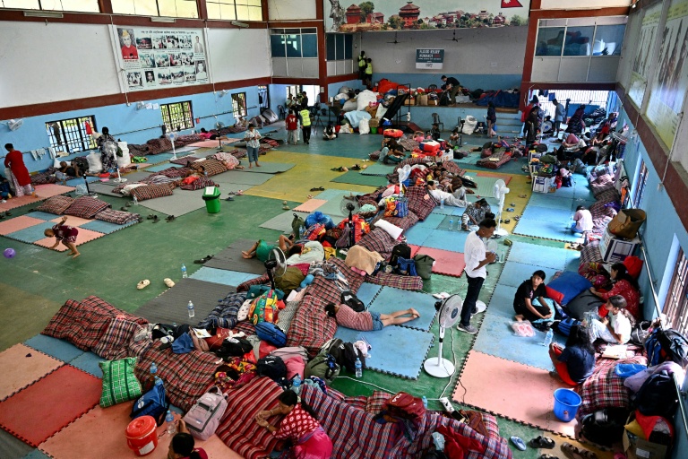 Flash flood survivors rest inside a relief shelter at Devighat in Nepal's Nuwakot district on Sept 6, 2026. Sheltering with relatives or in temporary camps, survivors of devastating floods in Nepal say they can no longer rebuild their homes after the landscape was violently transformed, leaving them focused simply on survival.