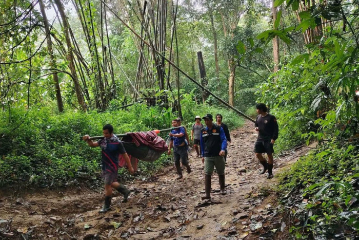 Bedridden old woman carried 9km through rain to the bank - Bangkok Post