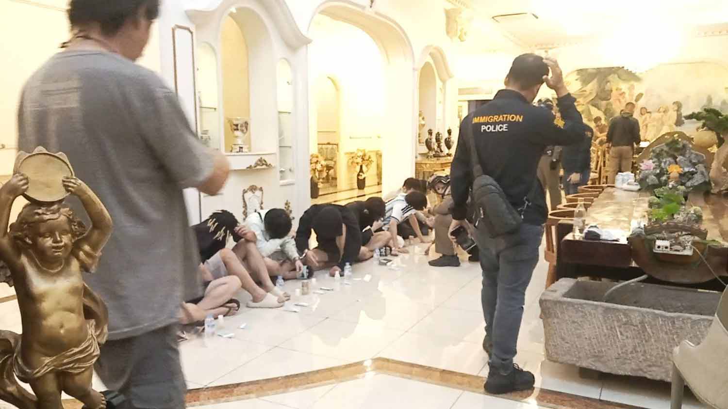 Police arrest scam suspects in the mansion.
