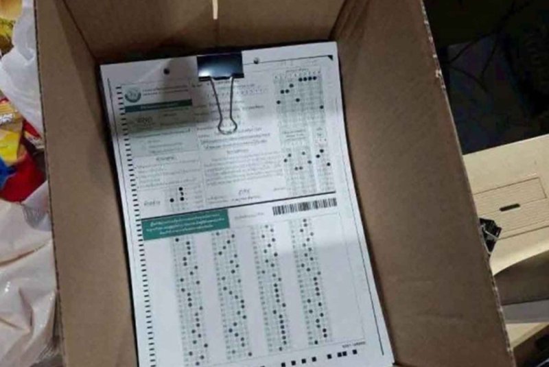 Police display examination paper seized during a raid on an office where officials were allegedly found tampering with examination results in June. (Police photo)