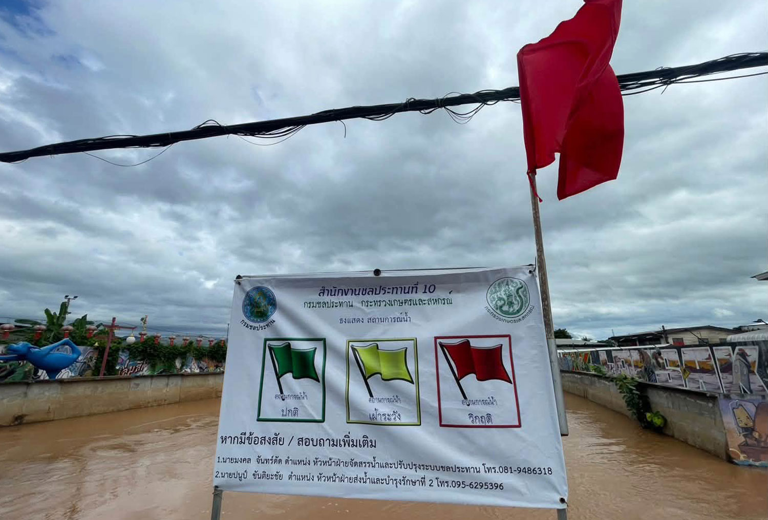 A red flag is put at Srisa-ard bridge in Lom Sak district of Phethabun province to warn residents about the critical water level of the Pasak River. (Photo: Lomsak police station) 
