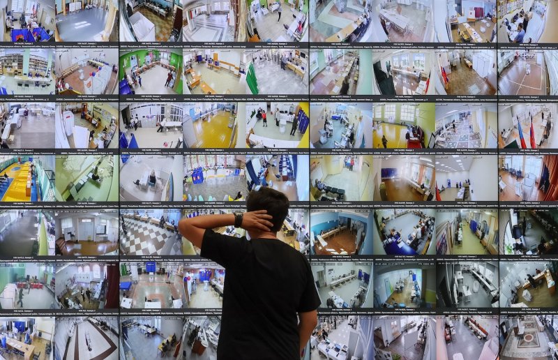 A man looks at screens showing live feeds from polling stations across the country at the headquarters of the Central Election Commission on the first day of Russia’s parliamentary election, in Moscow on Sept 18, 2026. (Photo: AFP)