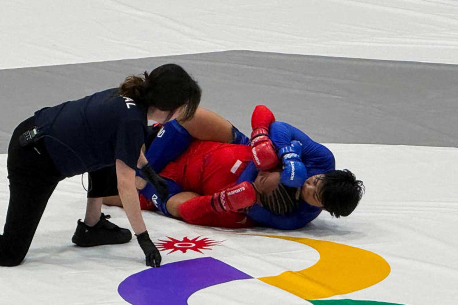 Indonesia's Vallensia Fahira Hotmauli fights Thailand's Kanjutha Phattaraboonsorn in the women's 54kg semi-final of the mixed martial arts competition at the Asian Games in Nagoya, Japan, September 21, 2026. Picture taken with a mobile phone. REUTERS