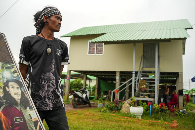 Tattoo artist Cheng Bora poses in front of his house in Rong Cham, a resettlement site villagers have nicknamed "the waiting village", home to families who fled fighting along the Cambodia-Thailand border and are waiting for a chance to return, in Banteay Meanchey province, Cambodia, on Sept 15, 2026. (Photo: Reuters)