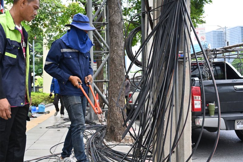 Workers from the Bangkok Metropolitan Administration and other agencies begin moving power and communication cables underground and removing those no longer in use on Rama V Road in Bangkok on Wednesday. (Photo: Bangkok Metropolitan Administration)
