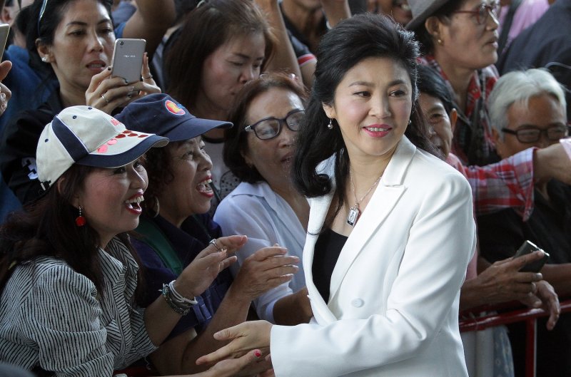 Yingluck Shinawatra greets supporters upon arriving at the Supreme Court for a hearing during her trial for dereliction of duty related to her government’s rice-pledging scheme, in June 2017. (Photo: Tawatchai Kemgumnerd)