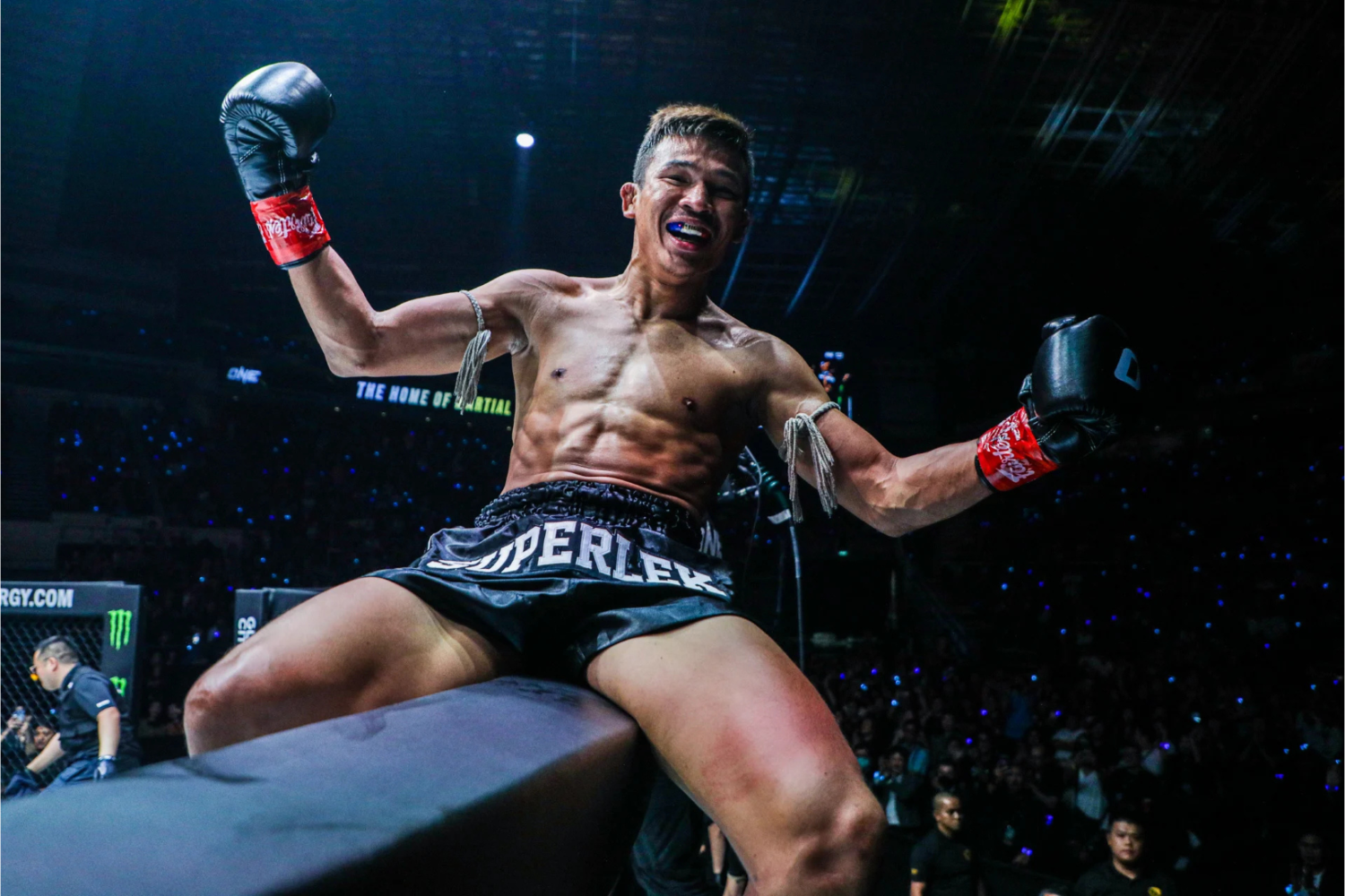 Superlek celebrates his first successful title defence &ndash; a knockout victory over Danial Williams &ndash; from the top of the ONE Championship cage in Singapore