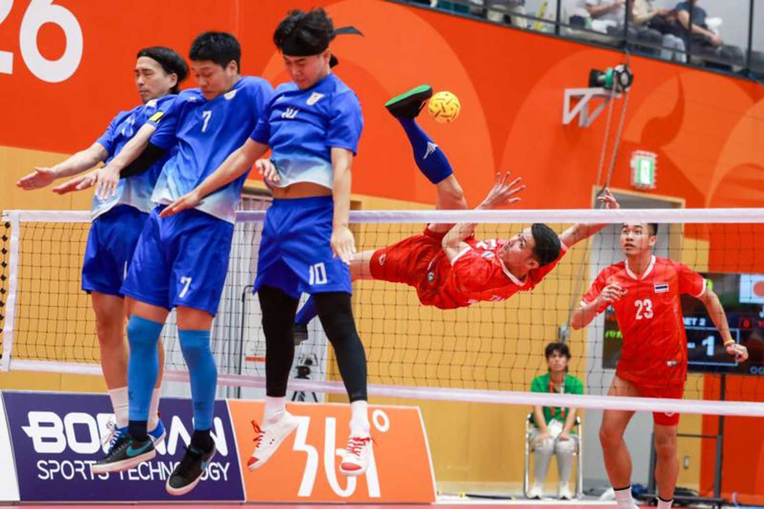 Thailand, red, in action against Japan in the sepak takraw men's regu team semi-finals. Takraw Association of Thailand