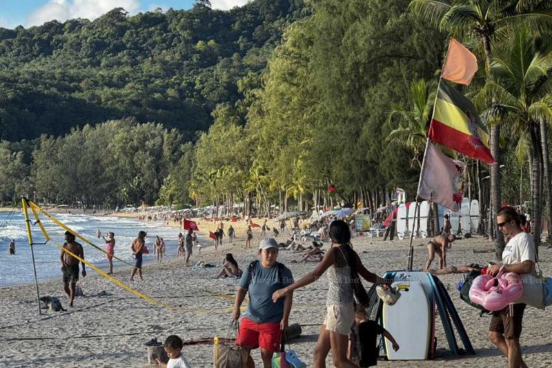 Tourists enjoy their vacation time on Kamala beach of Phuket last year. Molpasorn Shoowong