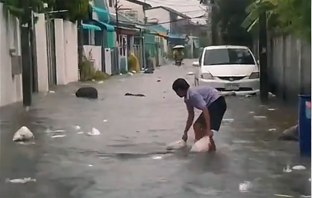 Schoolboy hailed for clearing rubbish from flooded city street