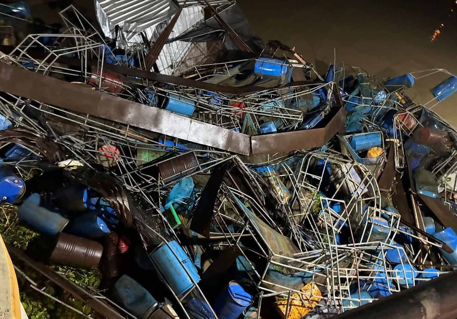 Wrecked parts of fish cages rest near the gates of the Mae Klong dam in Kanchanaburi.
