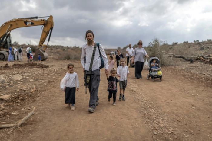 Israelis march between once-closed West Bank settlements