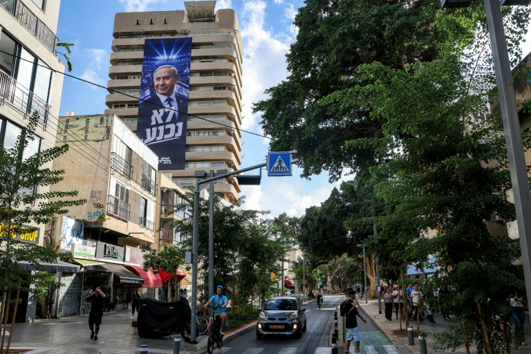 A giant electoral poster for Israeli Prime Minister Benjamin Netanyahu's Likud party with the slogan 'no surrender' on the facade of a building in Tel Aviv.