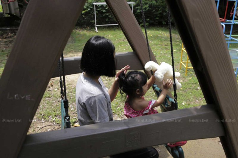 A teenage mum and her daughter play at a state half-way house in Bangkok’s Don Muang district. Bangkok Post file photo