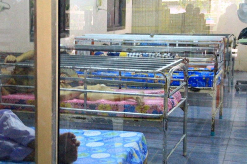 Beds with rows of steel bars attached above them are seen at an elderly care home in Kanchanaburi's Tha Muang district. The owner said the bars were to prevent residents from falling and getting injured. Piyarach Chongcharoen
