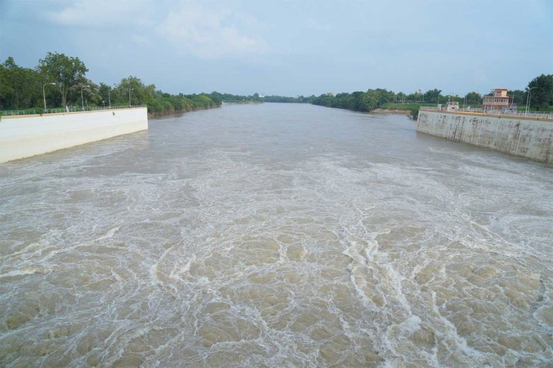 Water flows from the Mae Klong barrage in Kanchanaburi, which is among western provinces warned of severe flooding this weekend. Piyarach Chongcharoen
