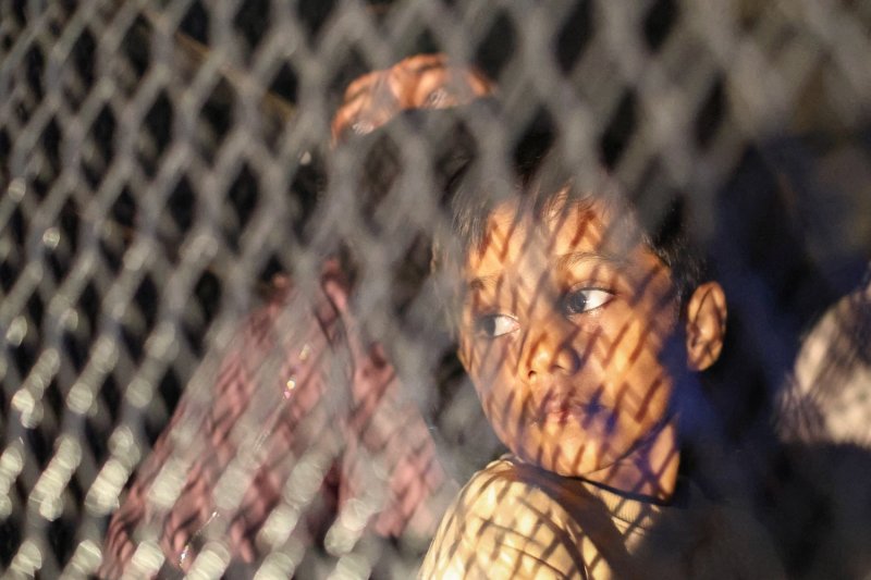 A boy looks out from a police vehicle after a group of Rohingya protesters were arrested in front of the office of the UN refugee agency in Kuala Lumpur on July 27, 2026. Malaysia’s rush to send Rohingya migrants back to Myanmar has been widely criticised by human rights groups. (Photo: Reuters)