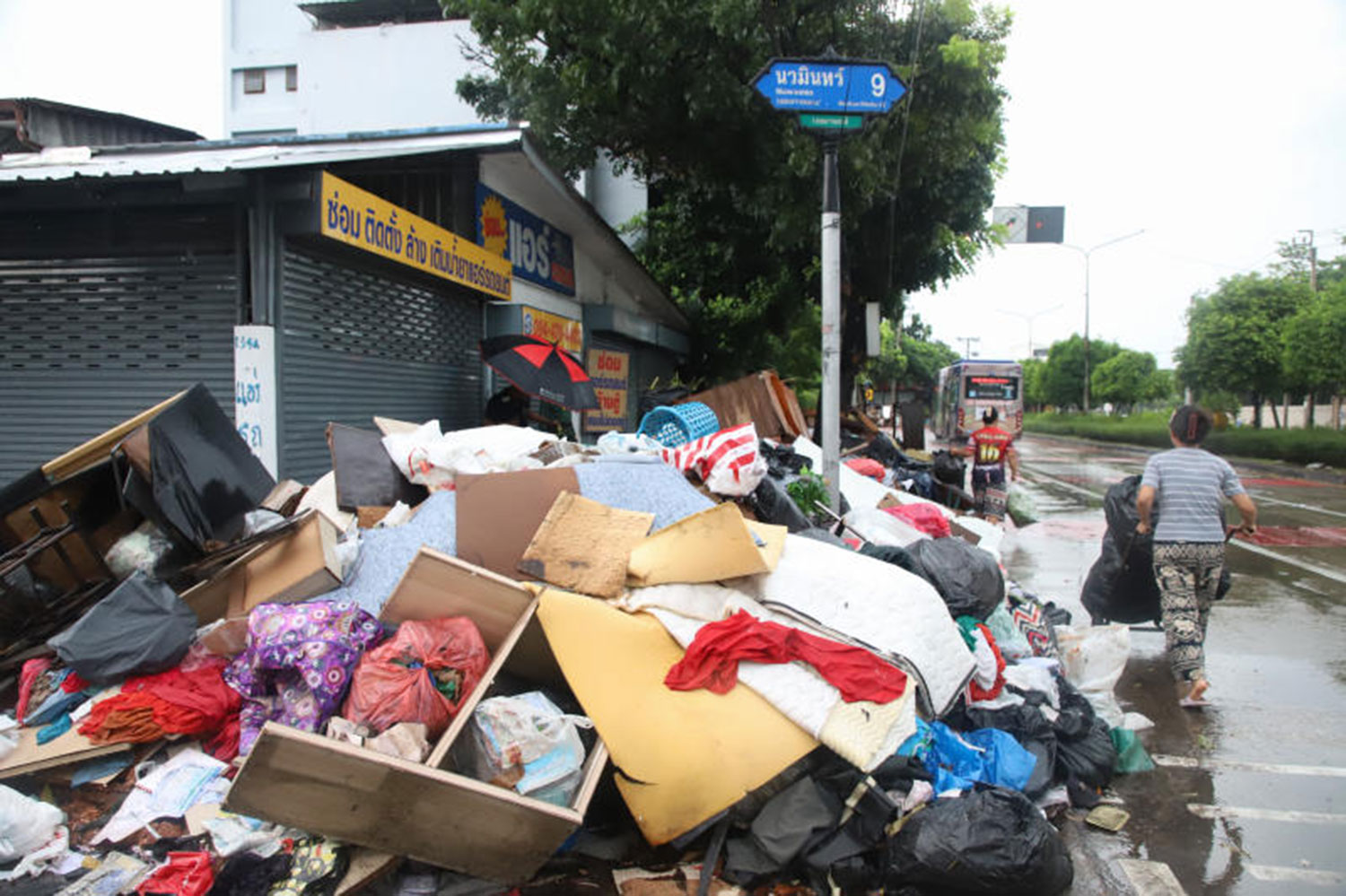 Rubbish awaiting collection piles up at the entrance to Soi Nawamin 6 in Bangkok’s Bang Kapi district on Oct 6, as the flood situation eases. (Photo: Varuth Hirunyatheb)