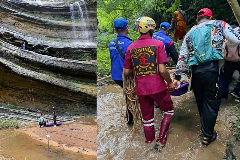 Rescuers carry one of the two injured tourists back up the cliff at Tat Mok Waterfall on Saturday. (Photo: Sunthorn Khongworakhom)