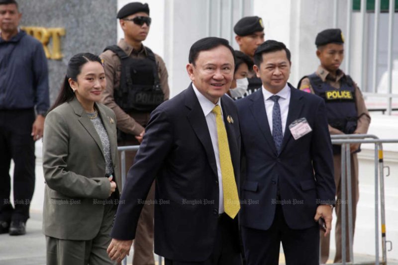 Winyat Chatmontree, right, is with Thaksin Shinawatra, centre, at the Supreme Court on Sept 9 last year. Pornprom Satrabhaya
