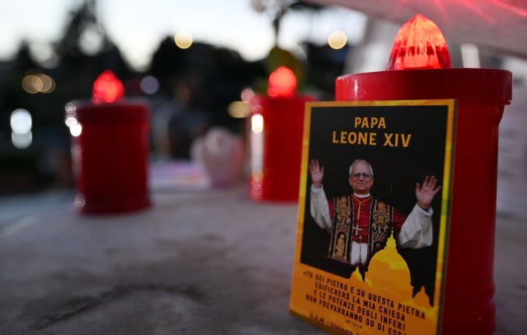 A picture of Pope Leo XIV and candles are laid outside the Gemelli University Hospital in Rome, where he is recovering after surgery to remove a cancerous tumour from his right lung. (Photo: AFP)