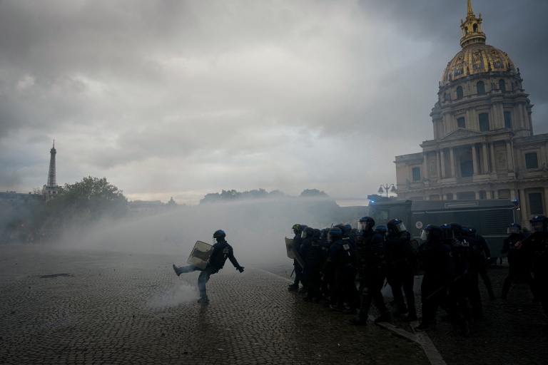 A protester kicks back a tear gas canister fired by police during a demonstration of high-school students in Paris on Oct 13, 2026. (Photo: AFP)