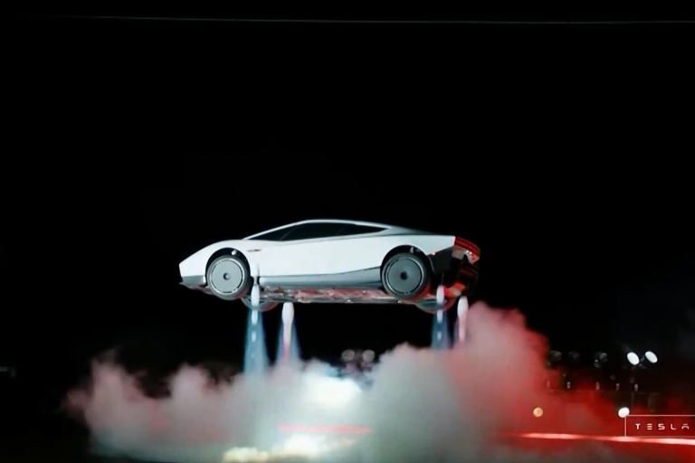 An image from a live feed released by Tesla shows its next-generation Roadster electric car descending after executing a barrel roll in midair at a SpaceX facility in McGregor, Texas on Oct 16, 2026. (Photo: Tesla via AFP)