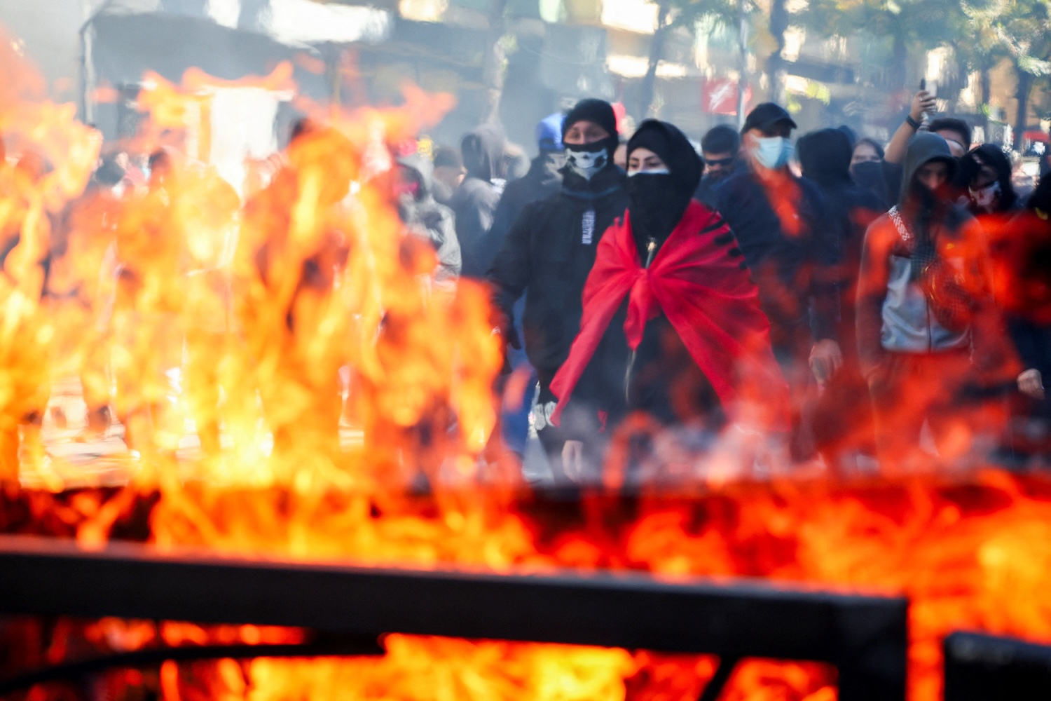 Protesters gather next to burning trash bins amid an anti-government protest by students in Tirana, Albania, on Oct 17, 2026. (Photo: Reuters)