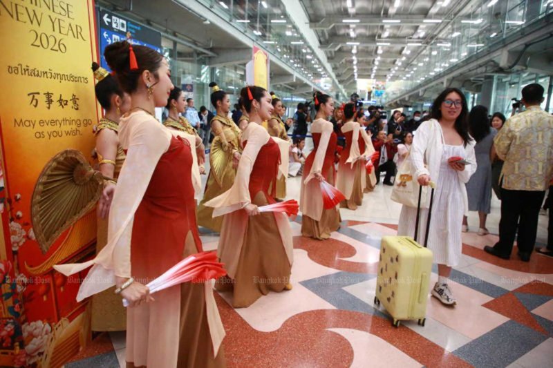 Visitors are greeted by performers at Suvarnabhumi airport as part of a welcoming event for passengers in celebration of the Chinese New Year 2026 at the International Arrivals Terminal.