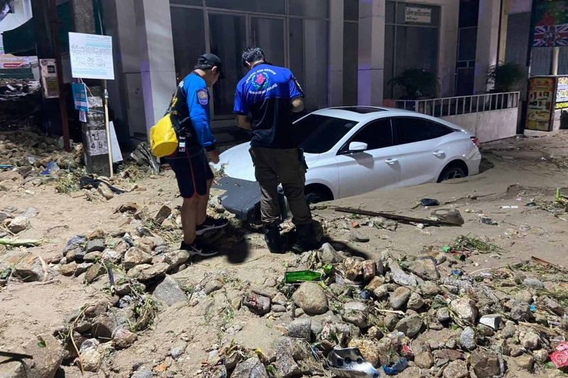 A car left mired in mud and rocks in Kathu district of Phuket early Monday morning. (Photos: Achadthaya Chuenniran)