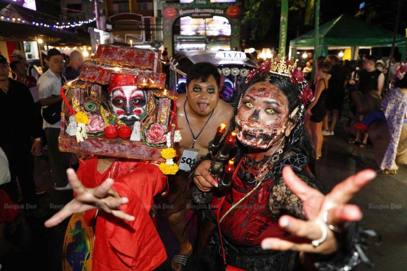 Costumed revellers parade along Khao San Road during the annual Halloween 2024 festival, themed "Beauty or Scary 2", promoting the area to Thai and international visitors. Pattarapong Chatpattarasill