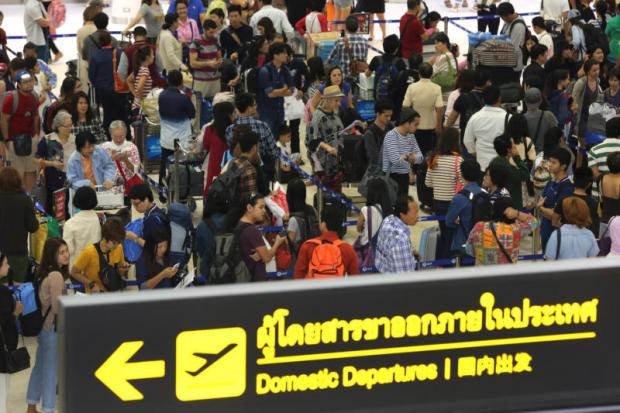 Passengers throng at Don Mueang airport. The Tourism and Sports Ministry says the baht's appreciation will weigh on inbound tourism. PATTANAPONG HIRUNARD