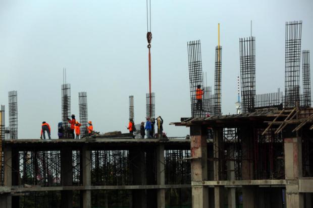 A condominium construction site in Bangkok. A former central bank governor is the latest to issue warnings about the property sector, plus strong words about cooperatives as well. Weerawong Wongpreedee