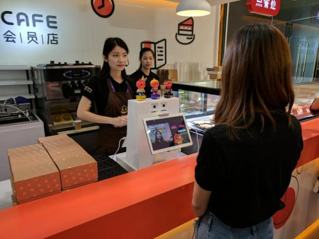 A customer orders coffee from Alibaba Group's experimental cashless retail store, Tao Cafe. It uses facial- and voice-recognition technology that lets customers leave their wallets at home.