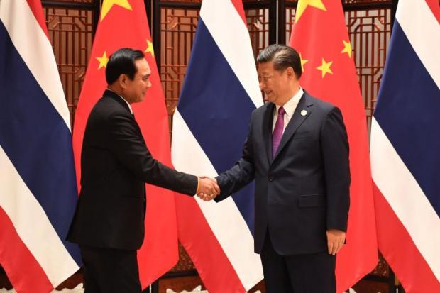 Prime Minister Prayut Chan-o-cha shakes hands on Monday with Chinese President Xi Jinping at the 9th Brics Summit in Xiamen. Thailand was invited as the only guest from Southeast Asia. (Government House photo)