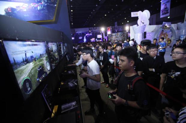 Visitors enjoy video games at a game show festival held in Bangkok. Games are a relatively unexploited area for advertisers. THANARAK KHUNTON