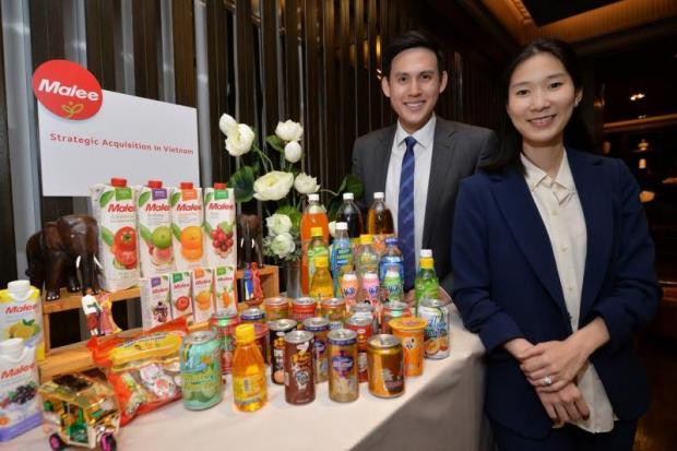 Roongchat Boonyarat, chief operating officer of Malee Group (right), and Opas Lopansri, senior vice-president of international business, display several of the company's products.